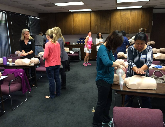 San Jose training center showing full class working on medical dummies