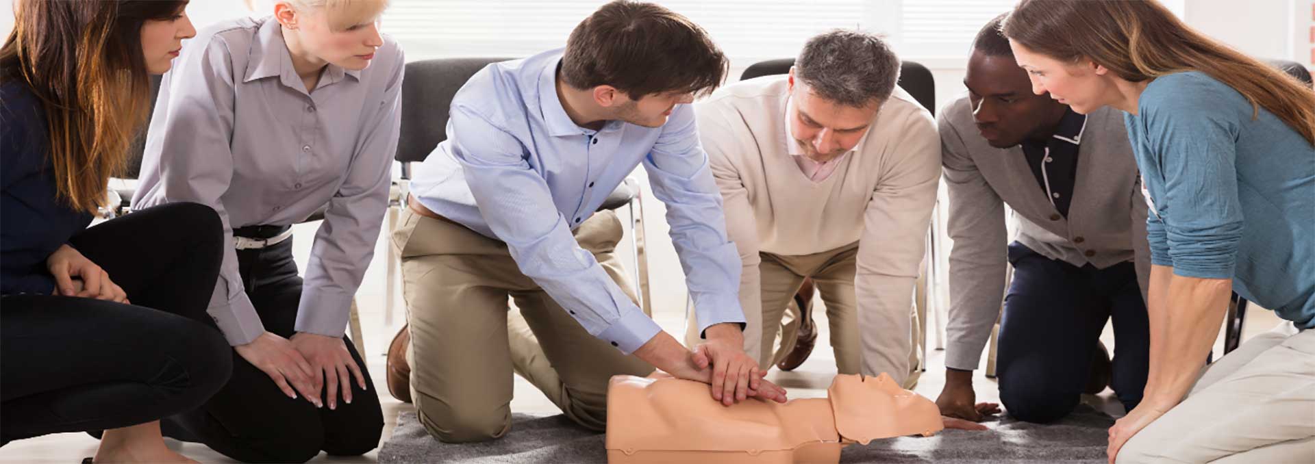 CPR class instructor demonstration on dummy